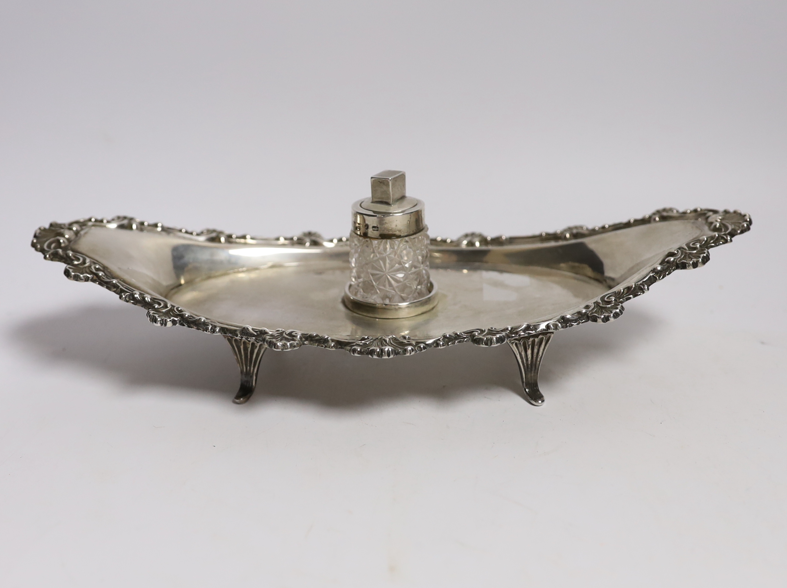 A late Victorian silver navette shaped inkstand, with silver mounted cut glass well, on four reeded feet, William Mammatt & Son, Sheffield, 1898, 27.7cm, 9.4oz.